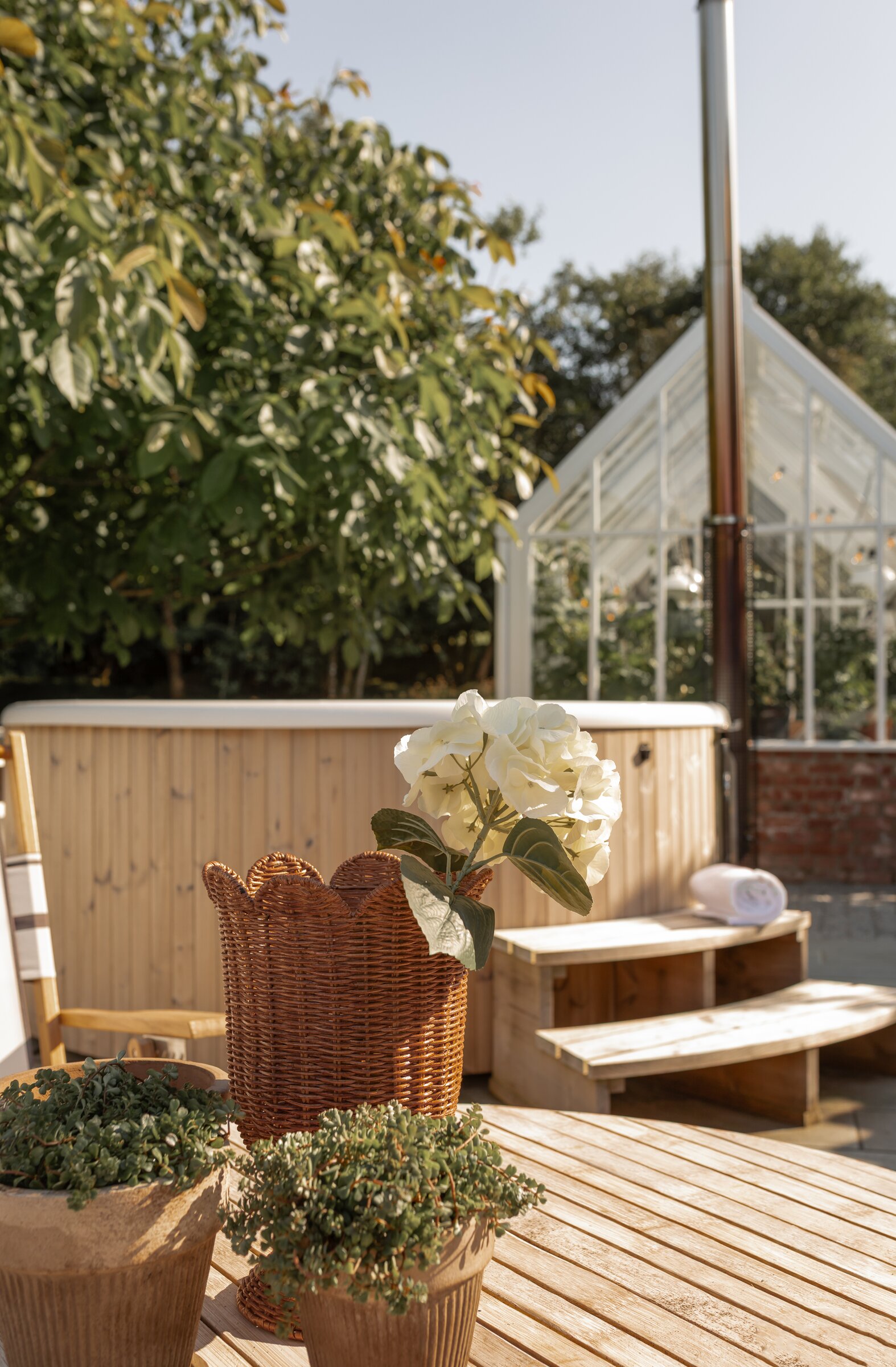 Wood-fired hot tub and greenhouse